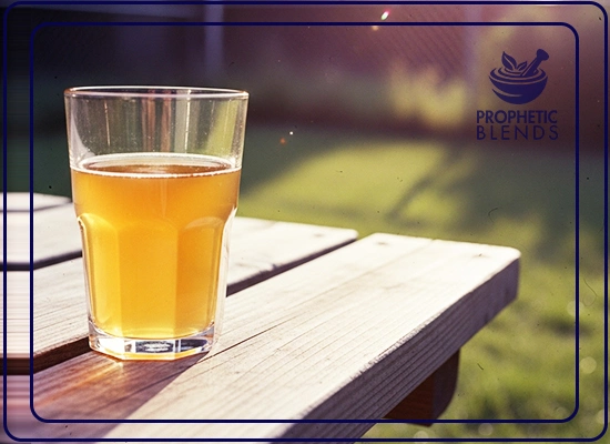clear glass of natural energy booster yemeni sidr honey drink in lukewarm water on a garden table