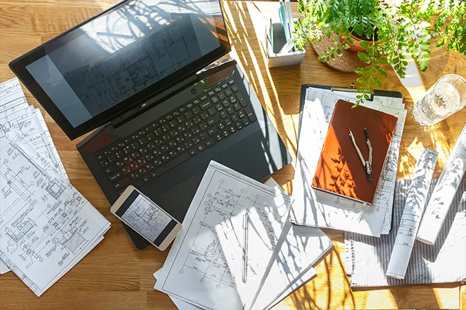 cluttered desk with digital devices symbolizing mental fatigue and nervous system overload