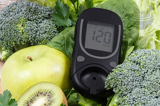 digital glucose meter surrounded by fresh green vegetables for diabetes section on sidr benefits blog