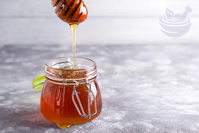 honey dripping into a jar with prophetic blends company logo