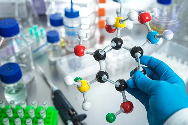 scientist holding a molecular model in a laboratory environment